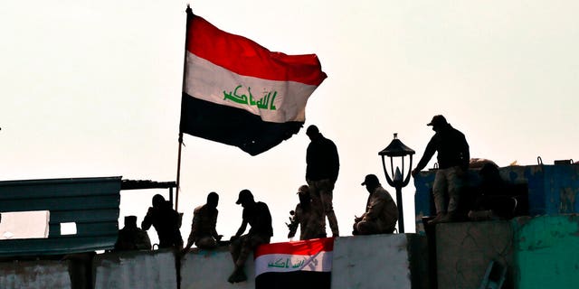 Security forces close the Ahrar Bridge during ongoing anti-government protests in Baghdad, Iraq, Monday, Dec. 9.