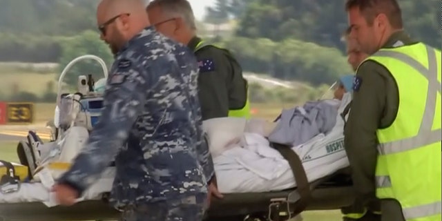 An injured tourist in the volcano eruption is carried to an Australian Air Force plane in Hamilton, New Zealand, Thursday, Dec. 12, 2019. N Australian Broadcasting Corporation via AP