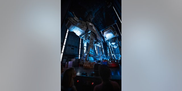 Guests race past massive AT-AT walkers aboard a First Order Star Destroyer as part of the groundbreaking new attraction.