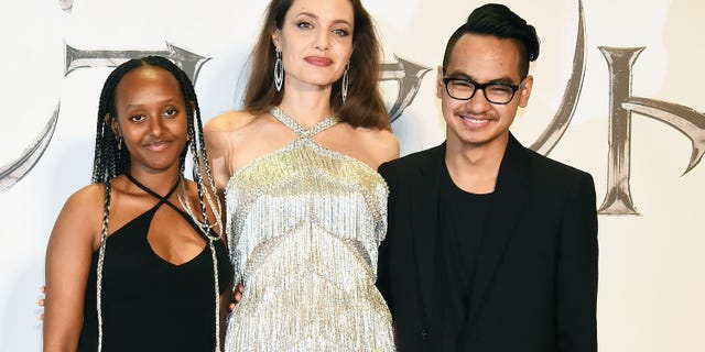 Angelina Jolie stands with daughter Zahara Marley and son Maddox, who she shares with Brad Pitt. (Photo by Jun Sato/WireImage)