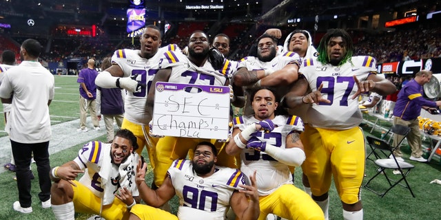 LSU players celebrate after the Southeastern Conference championship NCAA college football game against Georgia, Saturday, Dec. 7, 2019, in Atlanta. LSU won 37-10. (AP Photo/John Bazemore)