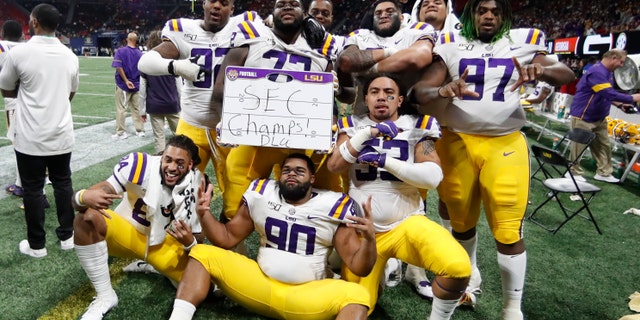 LSU players celebrate after the Southeastern Conference championship NCAA college football game against Georgia, Saturday, Dec. 7, 2019, in Atlanta. LSU won 37-10. (AP Photo/John Bazemore)