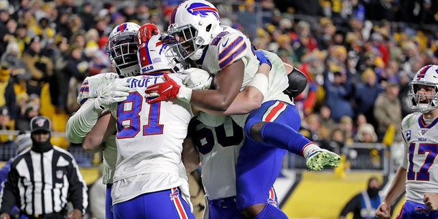 Buffalo Bills tight end Tyler Kroft (81) celebrates with running back Devin Singletary (26) and others after scoring on a pass from quarterback Josh Allen during the second half of an NFL football game against the Pittsburgh Steelers in Pittsburgh, Sunday, Dec. 15, 2019. (AP Photo/Don Wright)