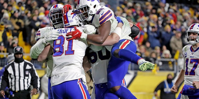 Buffalo Bills tight end Tyler Kroft (81) celebrates with running back Devin Singletary (26) and others after scoring on a pass from quarterback Josh Allen during the second half of an NFL football game against the Pittsburgh Steelers in Pittsburgh, Sunday, Dec. 15, 2019. (AP Photo/Don Wright)
