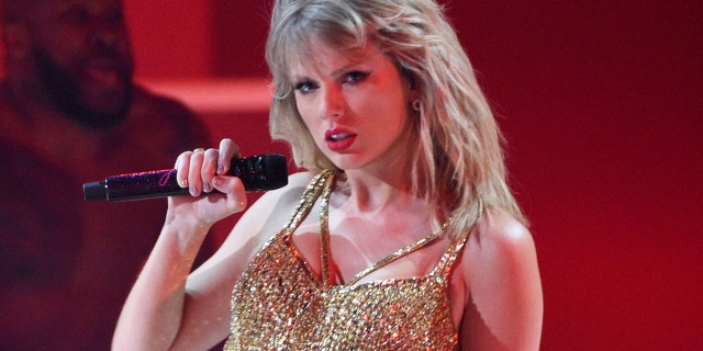FILE - This Nov. 24, 2019 file photo shows Taylor Swift performing at the American Music Awards in Los Angeles. A documentary on Swift will kickoff the next Sundance Film Festival. (Photo by Chris Pizzello/Invision/AP, File)
