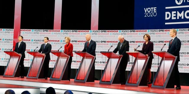 Democratic presidential candidates from left, entrepreneur Andrew Yang, South Bend Mayor Pete Buttigieg, Sen. Elizabeth Warren, D-Mass., former Vice President Joe Biden, Sen. Bernie Sanders, I-Vt., Sen. Amy Klobuchar, D-Minn., and businessman Tom Steyer stand on stage during a Democratic presidential primary debate Thursday, Dec. 19, 2019, in Los Angeles. (AP Photo/Chris Carlson)