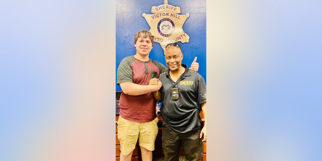 Bread deliveryman Joseph Chilton with Clayton County Sheriff Victor Hill.
