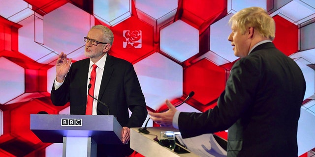 Opposition Labour Party leader Jeremy Corbyn, left, and Britain's Prime Minister Boris Johnson, during a head to head live Election Debate at the BBC TV studios in Maidstone, England, Friday Dec. 6, 2019. (Associated Press)