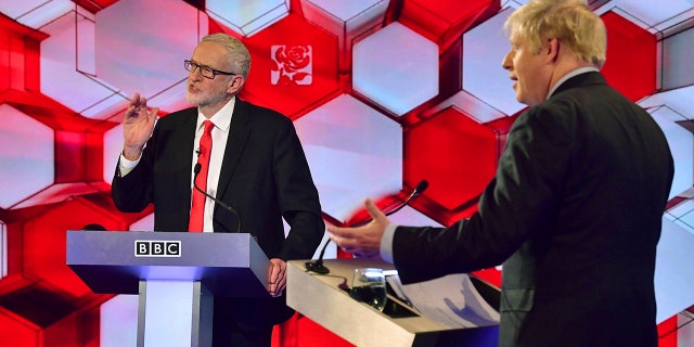 Opposition Labour Party leader Jeremy Corbyn, left, and Britain's Prime Minister Boris Johnson, during a head to head live Election Debate at the BBC TV studios in Maidstone, England, Friday Dec. 6, 2019. (Associated Press)