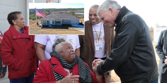 Franklin Graham, the president of Samaritan's Purse, shakes hands with Earnestine Reese, after revealing her new home that was destroyed by tornadoes in March.