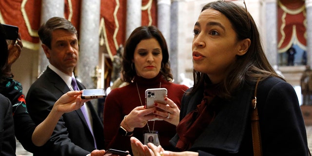 Rep. Alexandria Ocasio-Cortez, D-N.Y., speaks with reporters, Wednesday, Dec. 18, 2019, on Capitol Hill in Washington. President Donald Trump is on the cusp of being impeached by the House, with a historic debate set Wednesday on charges that he abused his power and obstructed Congress ahead of votes that will leave a defining mark on his tenure at the White House. (AP Photo/Patrick Semansky)