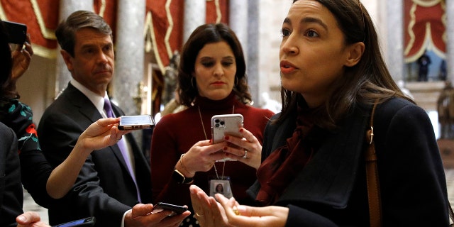 Rep. Alexandria Ocasio-Cortez, D-N.Y., speaks with reporters, Wednesday, Dec. 18, 2019, on Capitol Hill in Washington. President Donald Trump is on the cusp of being impeached by the House, with a historic debate set Wednesday on charges that he abused his power and obstructed Congress ahead of votes that will leave a defining mark on his tenure at the White House. (AP Photo/Patrick Semansky)