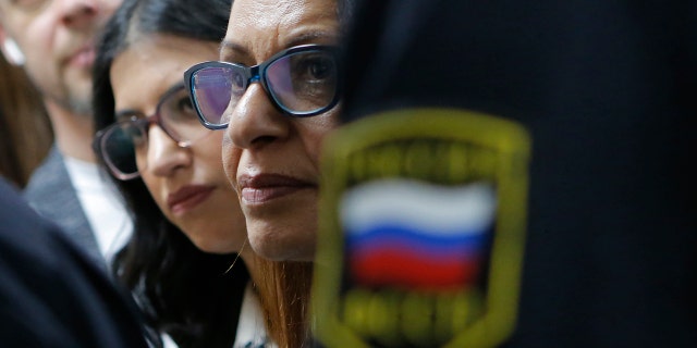 Israeli backpacker Naama Issachar's mother Yaffa Issachar, centre, and sister Liad Goldberg, left, wait to Issachar's appeal hearings in a courtroom in Moscow, Russia, Thursday, Dec. 19, 2019.
