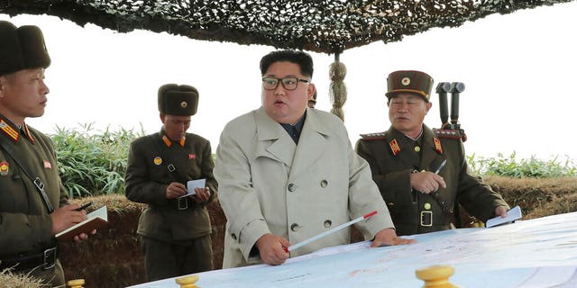 North Korean leader Kim Jong Un, center, inspects a military unit on Changrin Islet in North Korea. 
