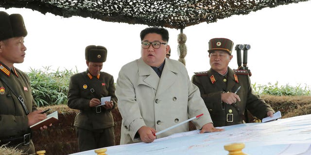 North Korean leader Kim Jong Un, center, inspects a military unit on Changrin Islet in North Korea. 