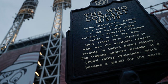 In this Wednesday, Nov. 20, 2019 photo, a memorial plaque for eleven concertgoers killed at a 1979 concert stands between Great American Ballpark and Heritage Bank Arena, in Cincinnati. Tragedy four decades ago linked the British rock band The Who to a small suburban city in Ohio. (AP Photo/John Minchillo)