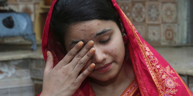 FILE - In this April 14, 2019 file photo, Pakistani Christian Mahek Liaqat, who married a Chinese national, cries as she narrates her ordeal, in Gujranwala, Pakistan. (AP Photo/K.M. Chaudary, File)