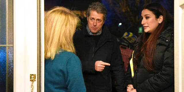 British actor Hugh Grant canvasses with Liberal Democrat Party candidate Luciana Berger, right, while on the general election campaign trail, in London, Sunday Dec. 1, 2019.