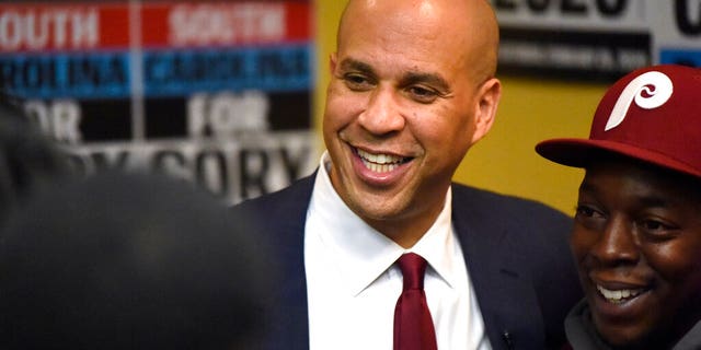 Democratic presidential contender Cory Booker poses for photos after a black men's round table on Monday, Dec. 2, 2019, in Columbia, S.C.