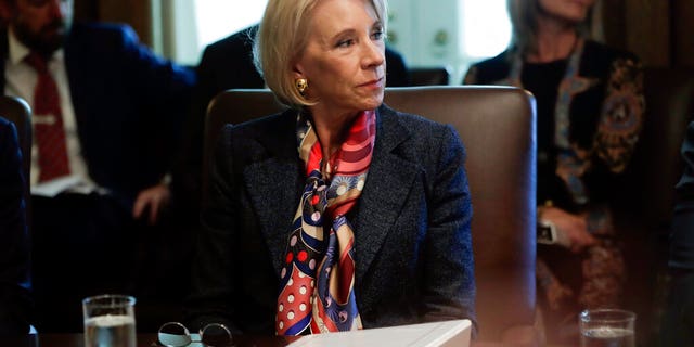 Education Secretary Betsy DeVos listened to President Trump during an October cabinet meeting at the White House. (AP Photo/Pablo Martinez Monsivais, File)