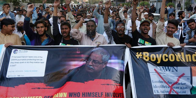 Dec. 3, 2019, photo, angry Islamists chant slogans during a demonstration against an independent Pakistani newspaper Dawn, at outside the Press Club in Karachi, Pakistan. (AP Photo/Fareed Khan)