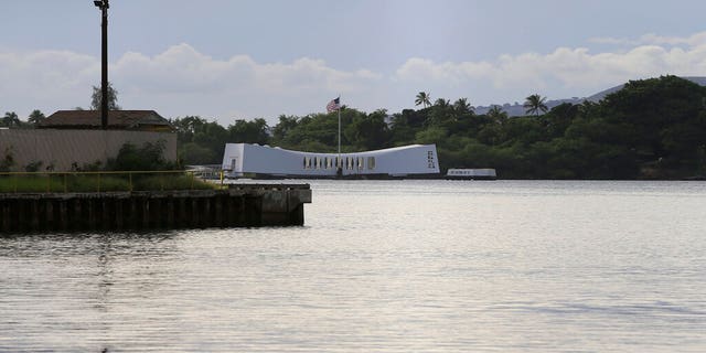 The USS Arizona Memorial can be seen from the Pearl Harbor National Memorial Wednesday, Dec. 4, 2019, in Honolulu. A U.S. sailor shot and wounded several civilian Department of Defense employees before taking their own life on Wednesday, the military said. The shipyard is across the harbor from the Pearl Harbor National Memorial. (AP Photo/Marco Garcia)