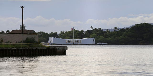 The USS Arizona Memorial can be seen from the Pearl Harbor National Memorial Wednesday, Dec. 4, 2019, in Honolulu. A U.S. sailor shot and wounded several civilian Department of Defense employees before taking their own life on Wednesday, the military said. The shipyard is across the harbor from the Pearl Harbor National Memorial. (AP Photo/Marco Garcia)