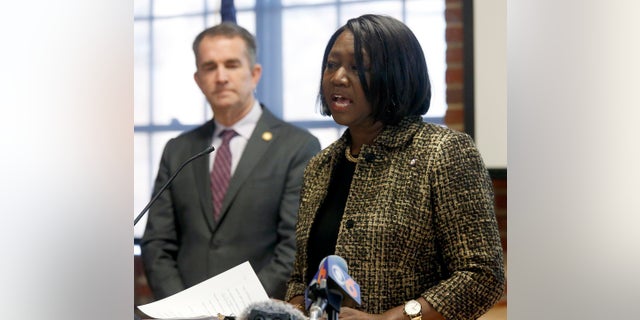 As Gov. Ralph Northam, left, looks on, Chief Deputy Attorney General Cynthia Hudson, left, addresses a gathering as she presented the report from The Commission to Examine Racial Inequity in Virginia Law in Richmond, Va., on Thursday. (Bob Brown/Richmond Times-Dispatch via AP)