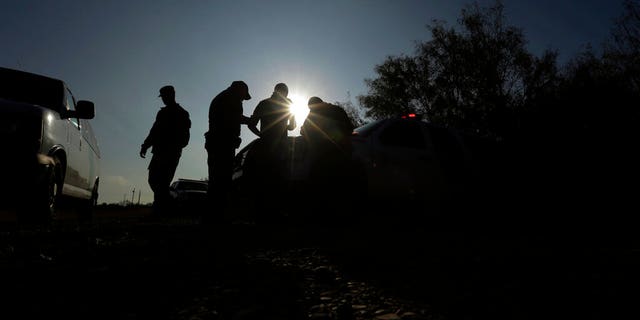 Border Patrol agents apprehending a man thought to have entered the country illegally, near McAllen, Texas, along the U.S.-Mexico border. 