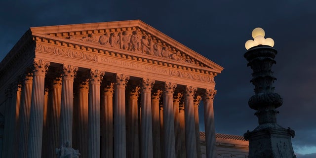 In this Jan. 24, 2019, file photo, the Supreme Court is seen at sunset in Washington. The Supreme Court is preventing the Trump administration from re-starting federal executions next week after a 16-year break. The court on Friday denied the administration's plea to undo a lower court ruling in favor of inmates who have been given execution dates. (AP Photo/J. Scott Applewhite, File)
