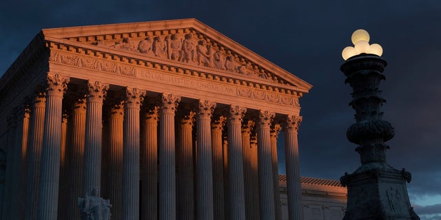 In this Jan. 24, 2019, file photo, the Supreme Court is seen at sunset in Washington. The Supreme Court is preventing the Trump administration from re-starting federal executions next week after a 16-year break. The court on Friday denied the administration's plea to undo a lower court ruling in favor of inmates who have been given execution dates. (AP Photo/J. Scott Applewhite, File)