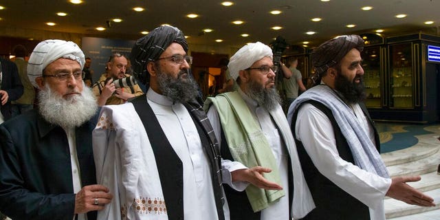 In this May 28, 2019, file photo, Mullah Abdul Ghani Baradar, the Taliban group's top political leader, second left, arrives with other members of the Taliban delegation for talks in Moscow, Russia. U.S. peace envoy Zalmay Khalilzad held on Saturday, Dec. 7, 2019 the first official talks with Afghanistan's Taliban since last September when President Donald Trump declared a near-certain peace deal with the insurgents dead. 