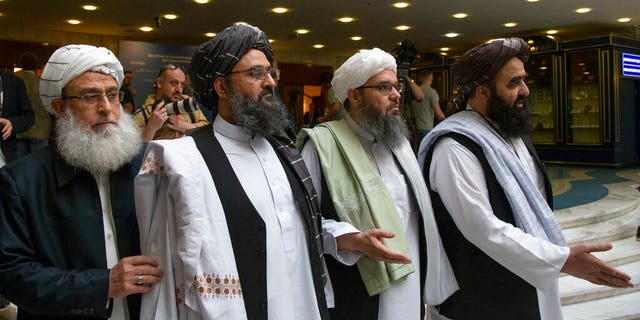 In this May 28, 2019, file photo, Mullah Abdul Ghani Baradar, the Taliban group's top political leader, second left, arrives with other members of the Taliban delegation for talks in Moscow, Russia. U.S. peace envoy Zalmay Khalilzad held on Saturday, Dec. 7, 2019 the first official talks with Afghanistan's Taliban since last September when President Donald Trump declared a near-certain peace deal with the insurgents dead.