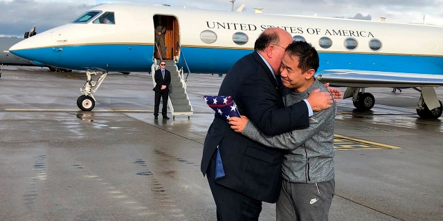 This photo provided by U.S. Embassy Switzerland, Edward McMullen greets Xiyue Wang in Zurich, Switzerland on Saturday, Dec. 7, 2019. In a trade conducted in Zurich, Iranian officials handed over Chinese-American graduate student Xiyue Wang, detained in Tehran since 2016, for scientist Massoud Soleimani, who had faced a federal trial in Georgia. (U.S. Embassy Switzerland via AP)
