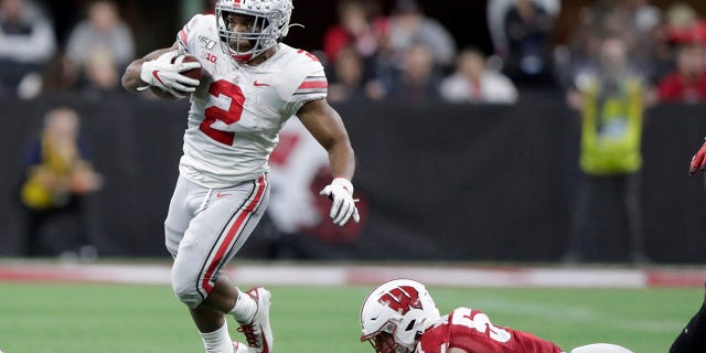 Ohio State running back J.K. Dobbins (2) runs past Wisconsin linebacker Jack Sanborn during the second half of the Big Ten championship NCAA college football game Saturday, Dec. 7, 2019, in Indianapolis. (Associated Press)