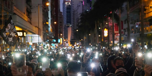Pro-democracy protesters march on a street during a protest in Hong Kong, Sunday, Dec. 8, 2019. Thousands of people took to the streets of Hong Kong on Sunday in a march seen as a test of the enduring appeal of an anti-government movement about to mark a half year of demonstrations. (AP Photo/Vincent Yu)