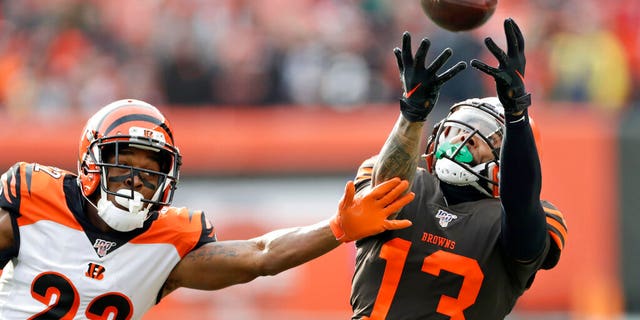 Cleveland Browns wide receiver Odell Beckham Jr. (13) can't hold onto the ball under pressure from Cincinnati Bengals cornerback William Jackson (22) during the first half of an NFL football game, Sunday, Dec. 8, 2019, in Cleveland. 