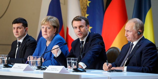 Ukrainian President Volodymyr Zelenskiy, left, German Chancellor Angela Merkel, French President Emmanuel Macron and Russian President Vladimir Putin, right, attend a joint press conference at the Elysee Palace in Paris on Monday Russian President Vladimir Putin and Ukrainian President Volodymyr Zelenskiy met for the first time on Monday at a summit in Paris to try to end five years of war between Ukrainian troops and Russian-backed separatists.  (Ludovic Marin / Swimming pool via AP)