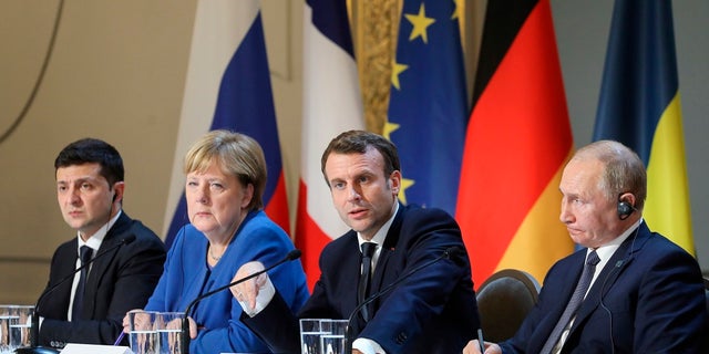 (Left to right) Ukraine's President Volodymyr Zelensky, German Chancellor Angela Merkel, French President Emmanuel Macron and Russian President Vladimir Putin at the joint news conference Monday in Paris. (Ludovic Marin/Pool via AP)