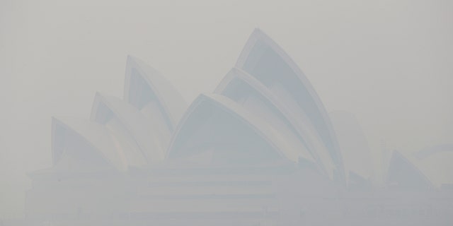 Thick smoke from wildfires shroud the Opera House in Sydney, Australia, Tuesday, Dec. 10, 2019. Hot dry conditions have brought an early start to the fire season. (AP Photo/Rick Rycroft)