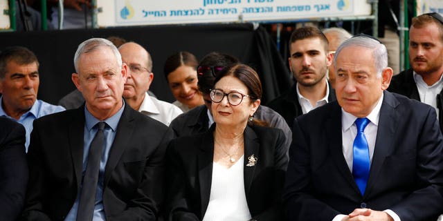 Blue and White party leader Benny Gantz, left, Esther Hayut, the Chief Justice of the Supreme Court of Israel, center, and Israeli Prime Minister Benjamin Netanyahu attend a memorial service for former President Shimon Peres in Jerusalem. 