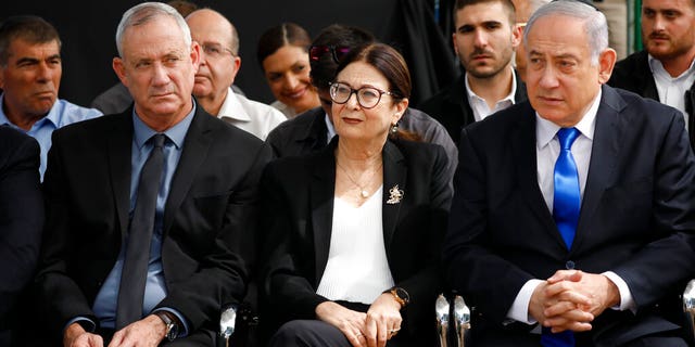 Blue and White party leader Benny Gantz, left, Esther Hayut, the Chief Justice of the Supreme Court of Israel, center, and Israeli Prime Minister Benjamin Netanyahu attend a memorial service for former President Shimon Peres in Jerusalem.