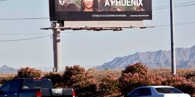 FILE: A University of Phoenix billboard is shown in Chandler, Ariz.
