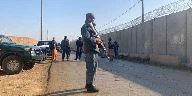 Security standing guard near the site of attack near Bagram Air Base.