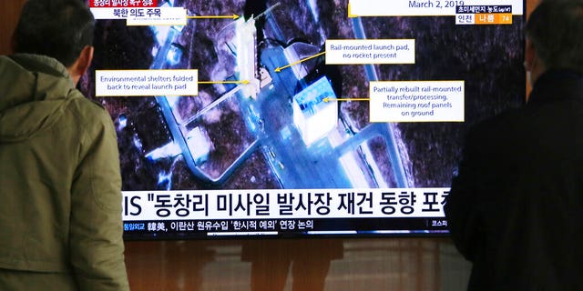 In this March 6, 2019, file photo, people watch a TV screen showing an image of the Sohae Satellite Launching Station in Tongchang-ri, North Korea, during a news program at the Seoul Railway Station in Seoul, South Korea. North Korea on Saturday, Dec. 14, says it successfully performed another "crucial test" as its long-range rocket launch site that would further strengthen its "reliable strategic nuclear deterrent."The signs read: " North's Tongchang-ri launch site." 