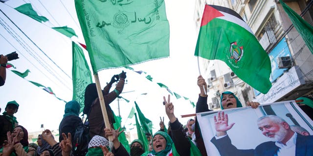 Israel claims Turkey is granting passports to Hamas members 4 Palestinian women, one holding a picture of Hamas movement chief, Ismail Haniyeh, attend a mass rally marking the 32nd anniversary of the founding of Hamas, an Islamic political party that currently rules in Gaza, Saturday, Dec. 14, 2019, in Gaza city. (AP Photo/Khalil Hamra)
