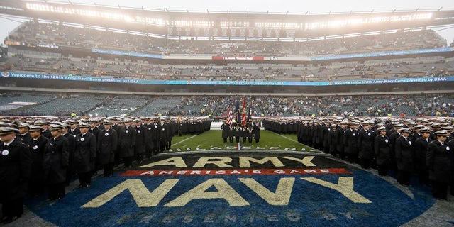 Navy midshipmen march before an NCAA college football game against Army on Dec. 14 in Philadelphia. A probe by both service academies into hand gestures displayed by West Point cadets and Naval Academy Midshipmen that were captured on national television concluded the signs were not intended to be racist. (AP Photo/Matt Slocum)