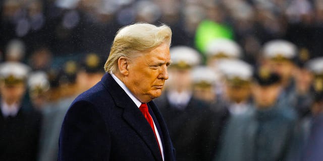 President Trump walks onto the field ahead of the annual Army-Navy football game, Dec. 14, 2019, in Philadelphia. (Associated Press)