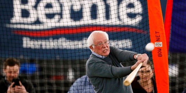 Sen. Bernie Sanders, I-Vt., hitting a baseball after a meeting with minor-league baseball players and officials Sunday in Burlington, Iowa. (AP Photo/Charlie Neibergall)