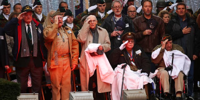 U.S. Battle of the Bulge veterans, front row, listen to the U.S. national anthem during a ceremony to commemorate the 75th anniversary of the Battle of the Bulge at the Mardasson Memorial in Bastogne, Belgium on Monday, Dec. 16, 2019. The Battle of the Bulge, also called Battle of the Ardennes, took place between Dec. 1944 and Jan. 1945 and was the last major German offensive on the Western Front during World War II.
